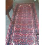 A red ground Iranian Runner with an all over pattern. 250 x 112cm.