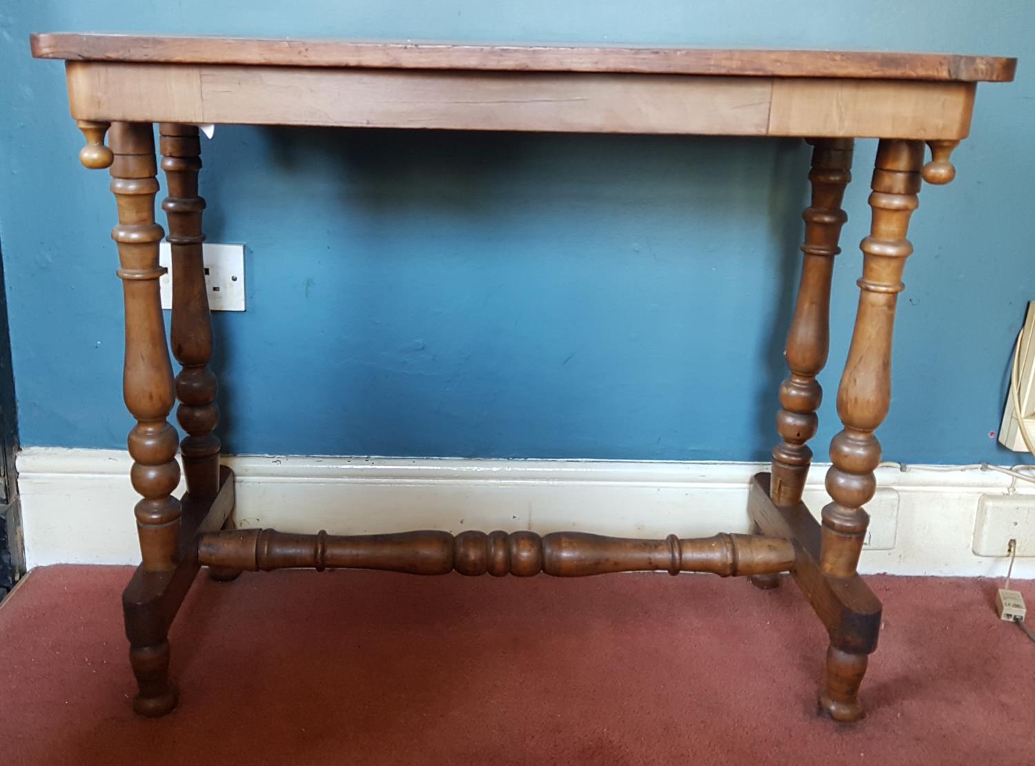 A Victorian Walnut Games Table with a stretcher base.