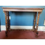 A Victorian Walnut Games Table with a stretcher base.