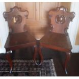 A superb pair of 19th Century Mahogany Hall Chairs.