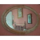 A 19th Century Oval Stripped Pine Mirror.