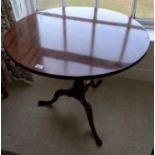 A Georgian Mahogany Supper Table with a simple splayed pod and tilting movement. 83 cms diam.