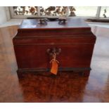 A Georgian Mahogany Tea Caddy of Sarcophagus form with original key. with key.