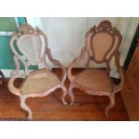 Two 19th Century stripped and waxed easy Armchairs with cane seats and backs.