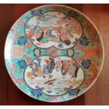 A very large early Oriental Charger with hand painted decoration.