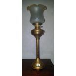 A 19th Century Brass Oil Lamp with a glass shade.