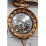 A late 19th Century early 20th Century Gilt Convex Mirror with eagle surmount.