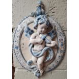 A pair of Porcelain wall mounted Plaques of Cherubs.