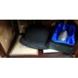 A quantity of items on three shelves to include a Bowler Hat.