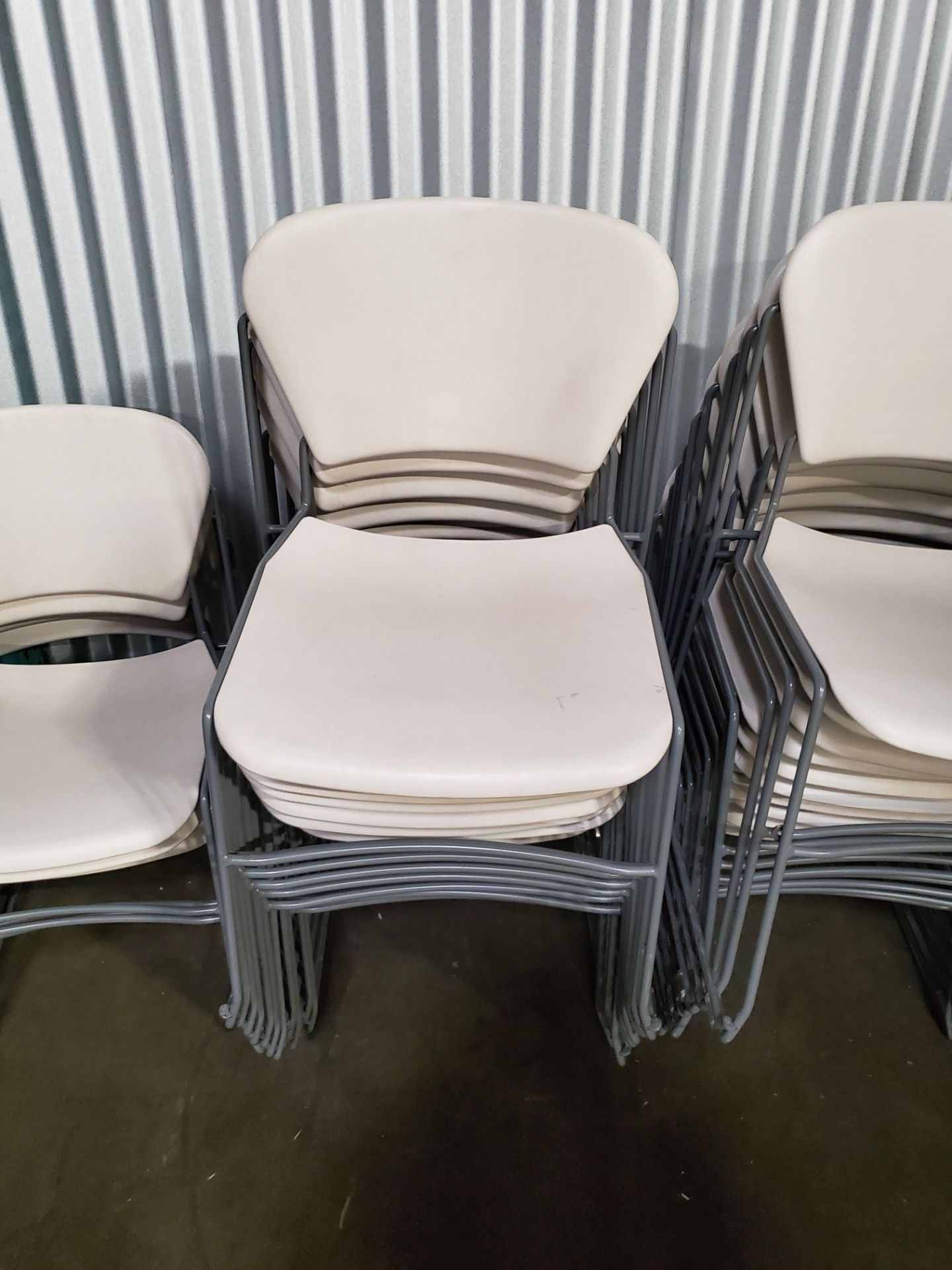 White Plastic and Chrome Stackable Chairs