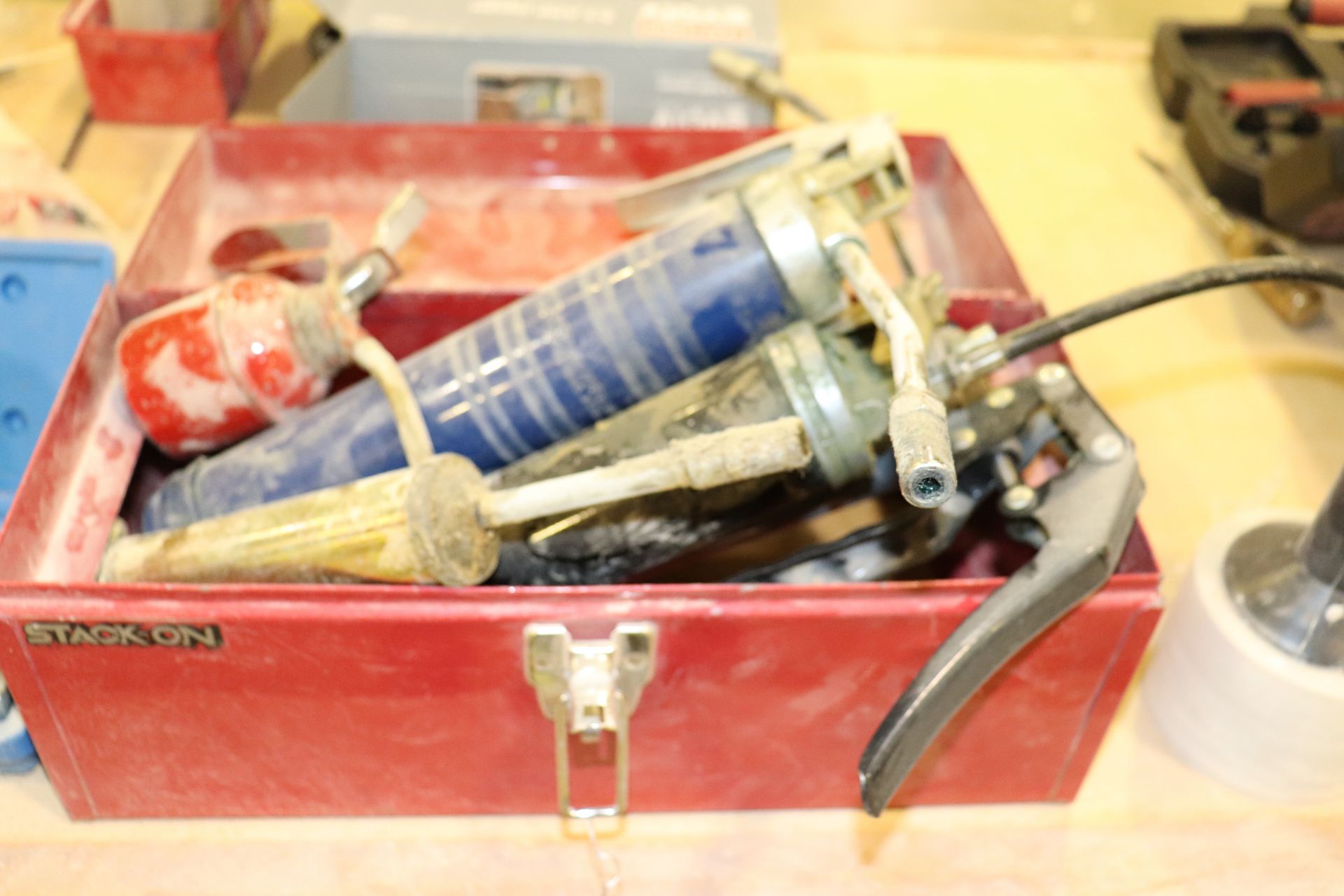 Stack on toolbox with grease guns