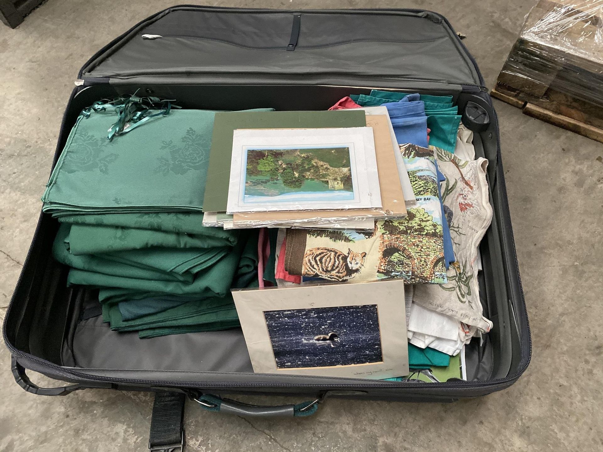 Suitcase full of Green Table Cloths and More