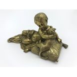 ANTIQUE BRONZE FIGURINE OF A YOUNG CHILD HOLDING CAT SITTING ON PILLOW (PAPERWEIGHT)