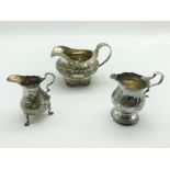 THREE GEORGIAN SILVER MILK JUGS