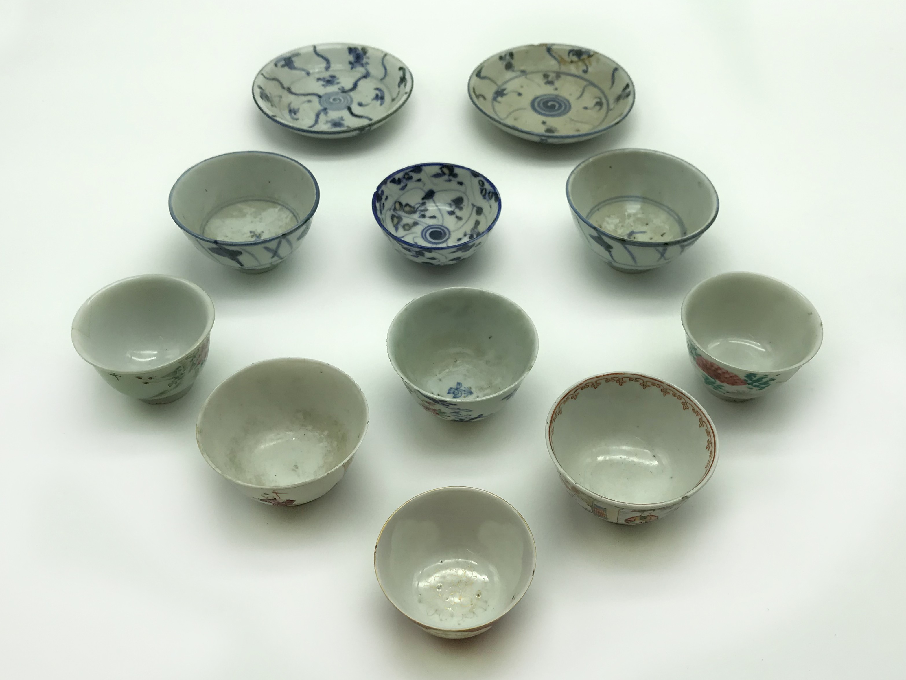 NINE ORIENTAL TEA CUPS AND TWO SAUCERS
