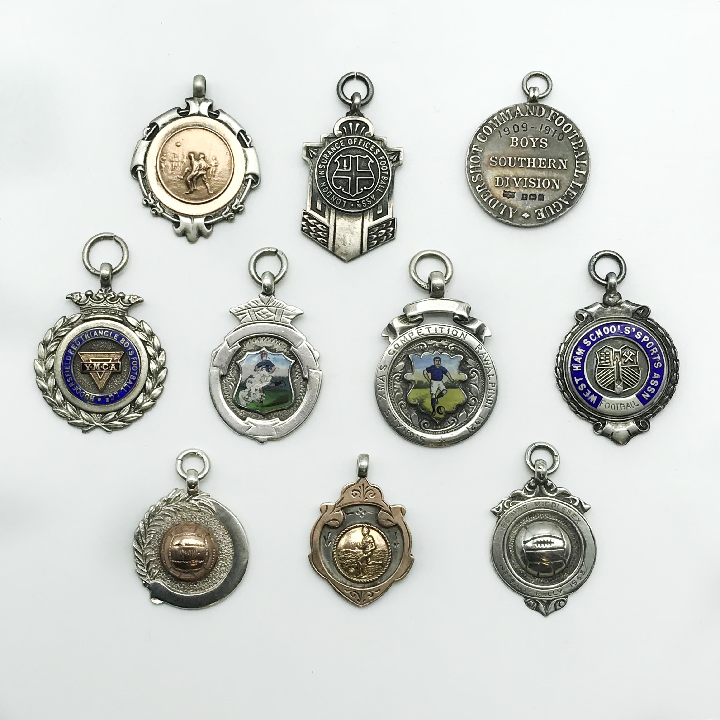 FOOTBALL RELATED TEN HALLMARKED SILVER FOBS AND PENDANTS