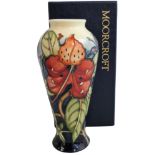 A Moorcroft 'Simeon' pattern baluster vase, tube lined and decorated in blue, green and red, painted