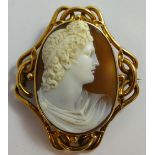 A Victorian gold mounted cameo brooch, unmarked, depicting a classical youth, scroll surround, 6 x