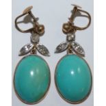 A pair of turquoise and diamond earrings, the collet set oval cabochon stones, length 22 mm, with