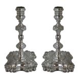 A George II pair of cast silver candlesticks, by Thomas Gilpin, London 1747, the cotton reel sconces