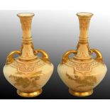 A Royal Worcester pair of blush ivory porcelain dolphin-handled vases, gilt and polychrome enamel
