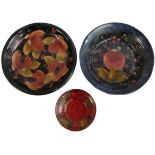 A Moorcroft 'Leaf and Berry' pattern flambé fired saucer, signed 'WM' (William Moorcroft),