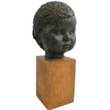 A bronze bust of a young child, rough finish, unsigned, mounted on a oak pedestal, overall height 32