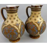 A pair of Mettlach jugs of baluster form, the relief decoration depicting birds and flowers in