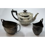 A Victorian silver three piece tea service, by Charles Stuart Harris, London 1888/89, of oval half