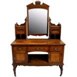 A Victorian oak dressing table, with three frieze drawers over an open shelf, flanked by