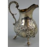A Victorian silver milk jug, by Henry Holland, London 1857, of baluster form, with embossed and