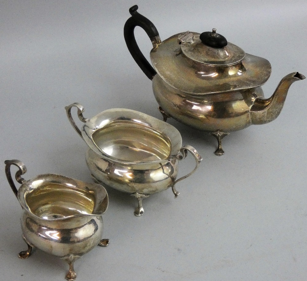 A silver three piece tea service, Birmingham 1922, of oval baluster form, raised on pad feet,