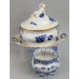 A Royal Copenhagen sauce tureen and cover with integral stand, the cover with putti playing a