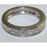 An 18ct white gold and colourless stone ring, stamped 750, channel set with ten Princess cut stones,