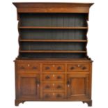 A Georgian oak dresser, the base with three frieze drawers over three dummy drawers, flanked by