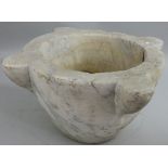 A large carved marble mortar, with four lugs, width 47 cm.