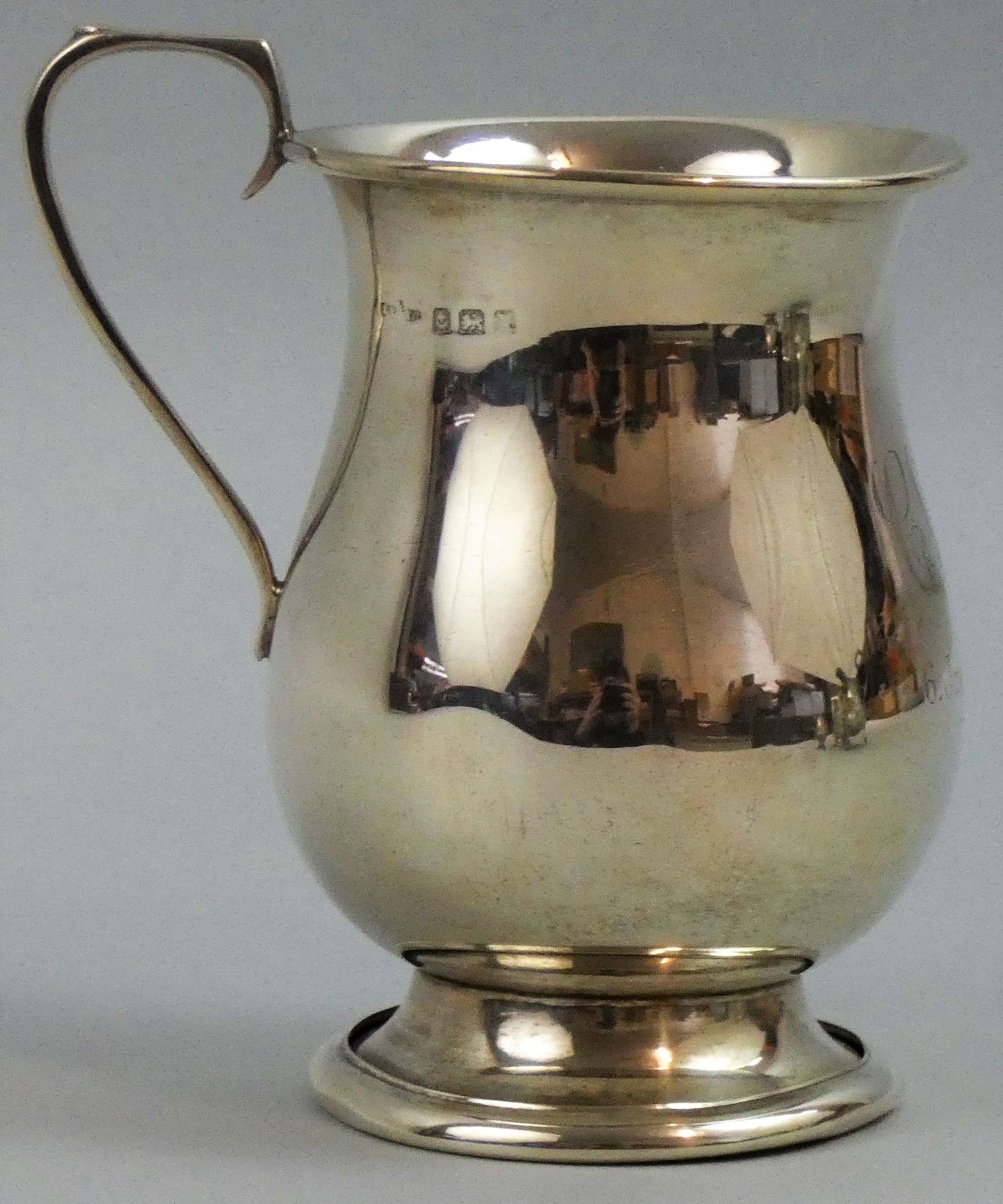 A silver christening mug, Birmingham, date letter worn, of baluster form, monogrammed and dated