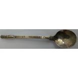 An Arts & Craft spoon, by D Ltd, Birmingham 1942, the hand beaten stem with King terminal, to a