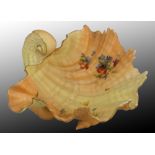 A Royal Worcester blush ivory open faced porcelain shell bowl raised on three conch feet, with