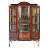 An Edwardian mahogany, boxwood and ebony inlaid display cabinet, the central domed glazed panel over