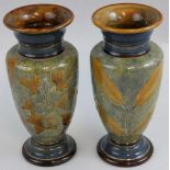 A pair of Victorian Doulton vases of baluster form, with blue and brown leaf decoration, monogram