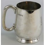 A silver christening mug, Chester 1920, of baluster form with C shape handle, monogrammed, weight