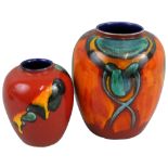 Two Poole Pottery vases of baluster form, one decorated with green yellow glaze on a red ground,