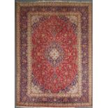 A central Persian Kashan carpet, the central blue field with red border, together with purchase