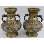 A pair of Japanese two-handled brass vases, of baluster form with three bands of enamel