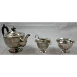 A silver three piece tea service, by Viners, Sheffield 1930, of circular panelled form, ebony handle