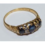 A Victorian 18ct gold three stone sapphire ring, Chester 1894, old cut diamond double points