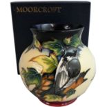 A Moorcroft 'Ingleswood' pattern squat vase, tube lined and decorated with birds and foliage in