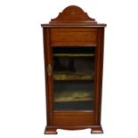 An Edwardian mahogany and boxwood inlaid glazed cabinet, the top with shell motifs, opening to