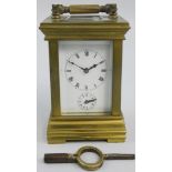 An early 20th century brass miniature alarm/carriage clock, the white enamel dial with Roman